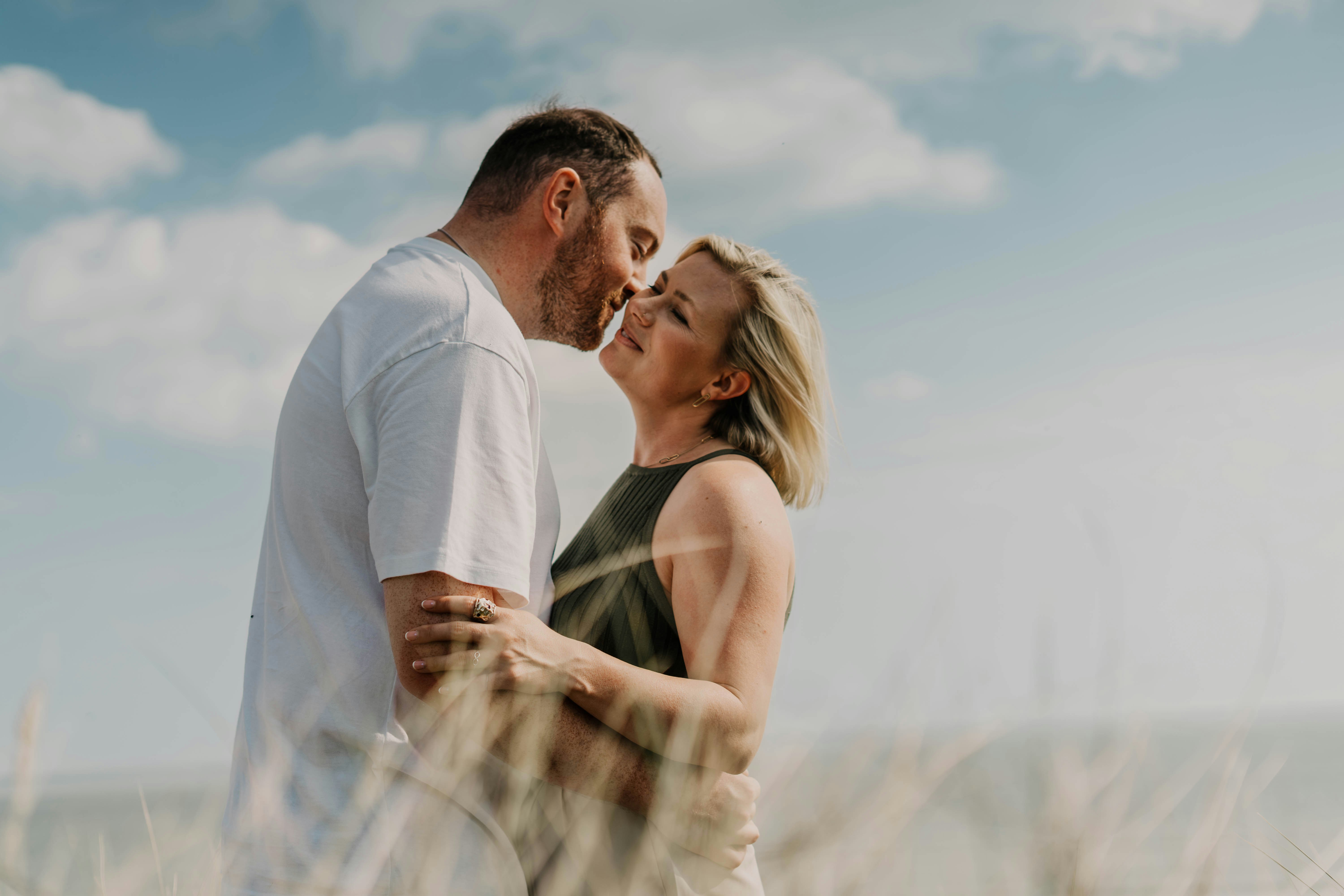 A happy couple embracing warmly, sharing a close, joyful moment together